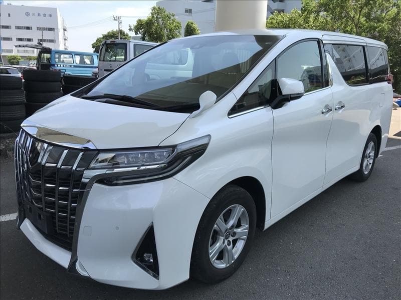 Белый автомобиль Toyota Alphard на площадке